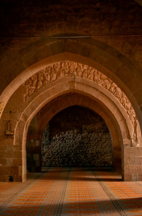 Free Majestic stone arches in a historic building's corridor create a timeless atmosphere. Stock Photo