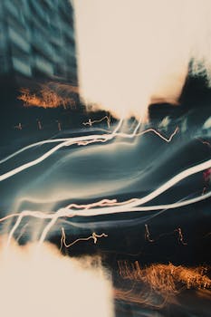 Abstract light trails in a cityscape create a dynamic, urban nighttime scene.