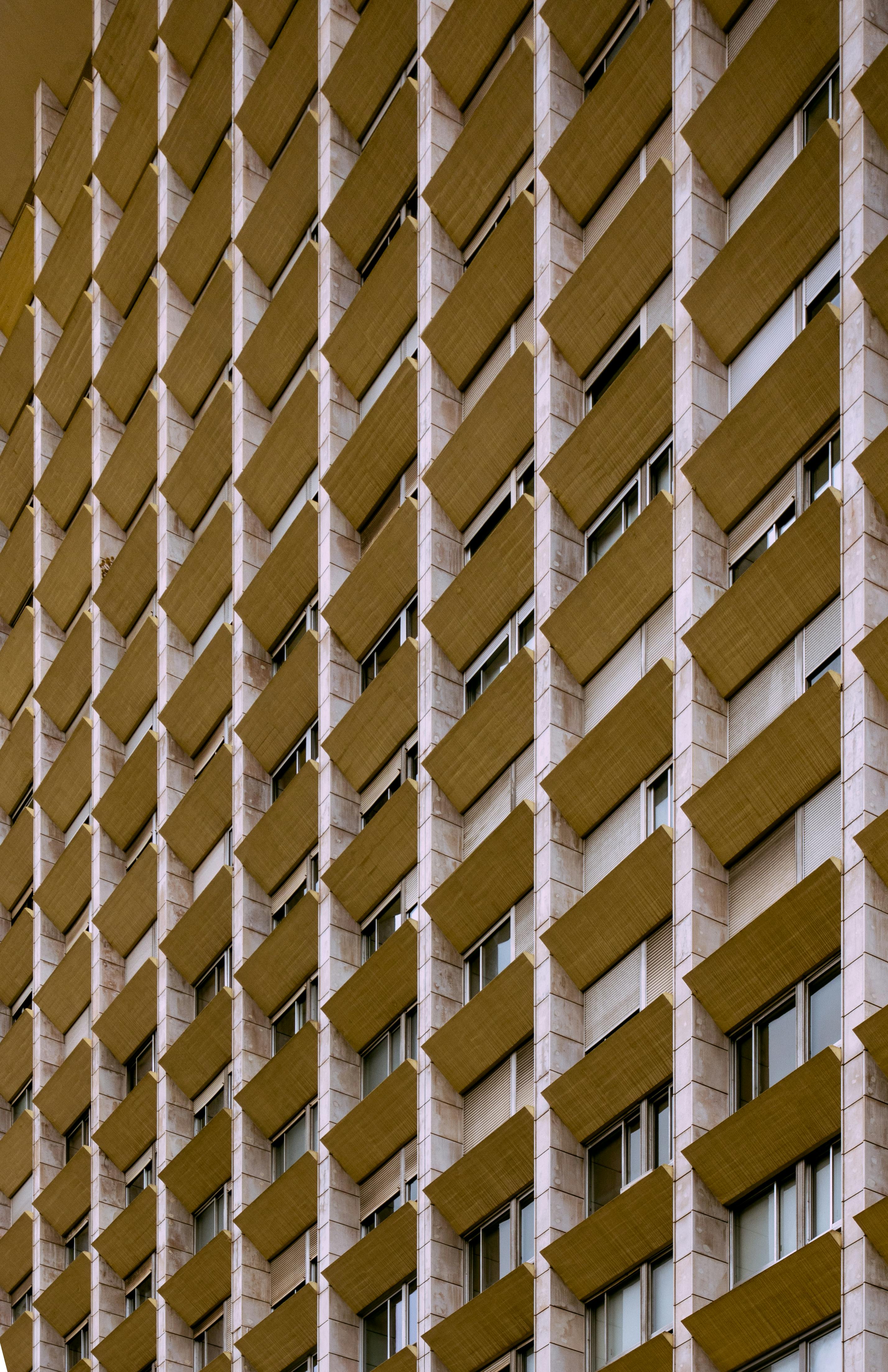 A close-up view of a modern apartment building facade in Lisbon, showcasing geometric patterns.