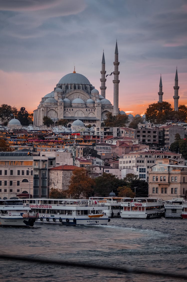 Waterfront With Mosque And Ferries On The Sea