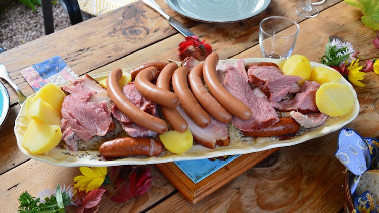 Sliced Meat And Hotdogs On Yellow Plate