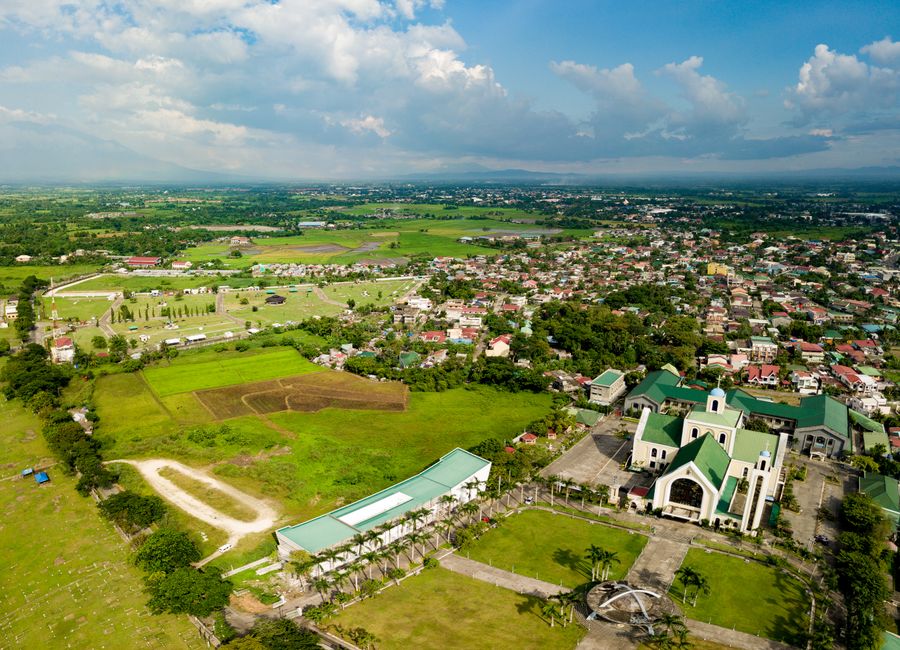 Stunning aerial shot of Naga City showcasing the Penafrancia Basilica and lush green fields.