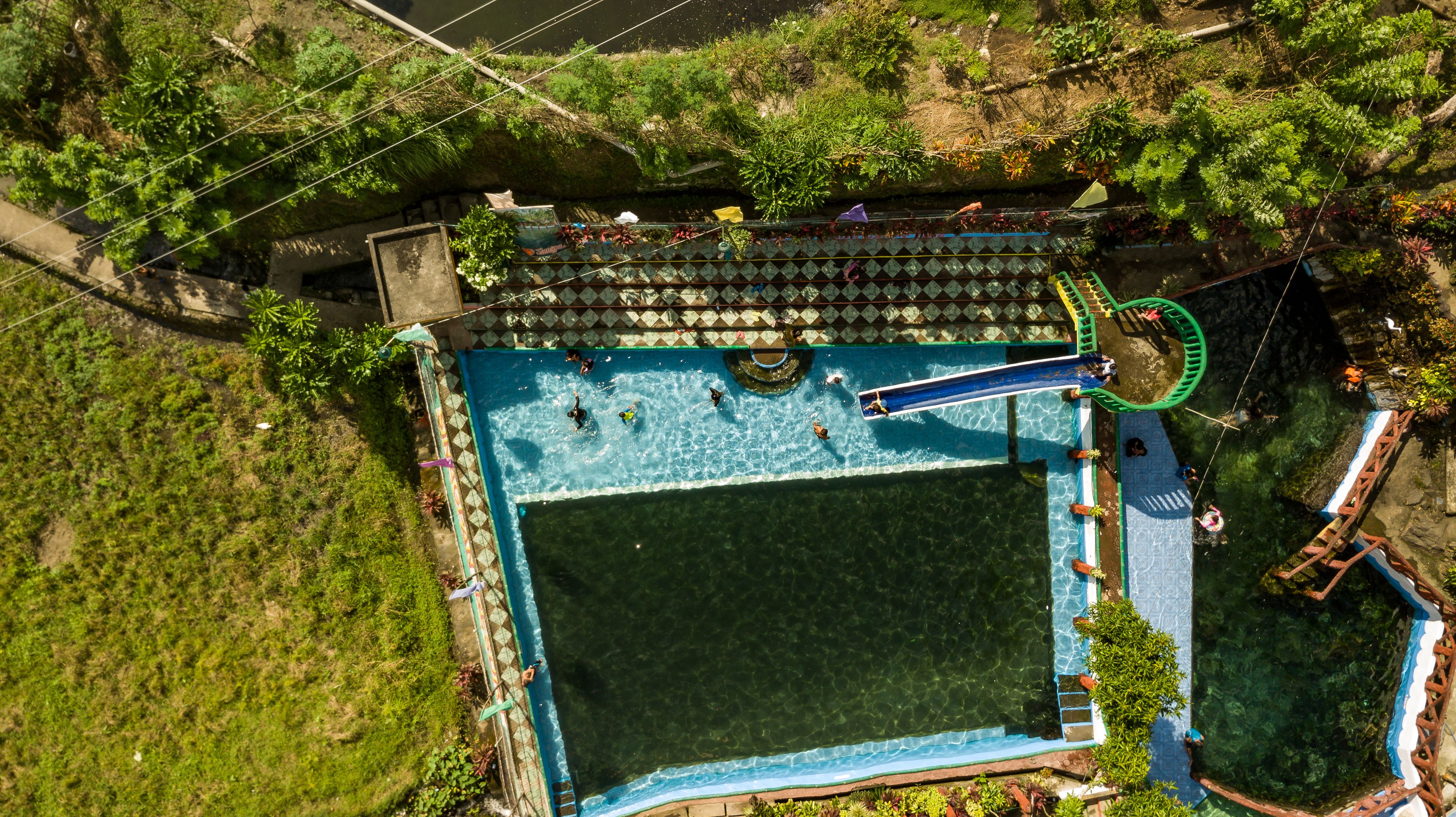 People enjoying a sunny day in a residential-style outdoor pool