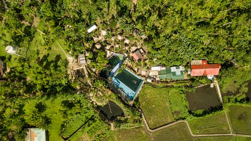 Free A stunning aerial shot capturing a rural landscape with pools, lush green fields, and scattered houses. Stock Photo
