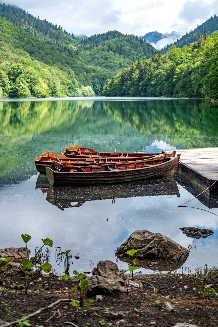 Brown Wooden Boat On Lake