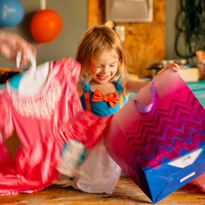 Child opening a brightly coloured gift bag — photo by Tom Fisk on Pexels