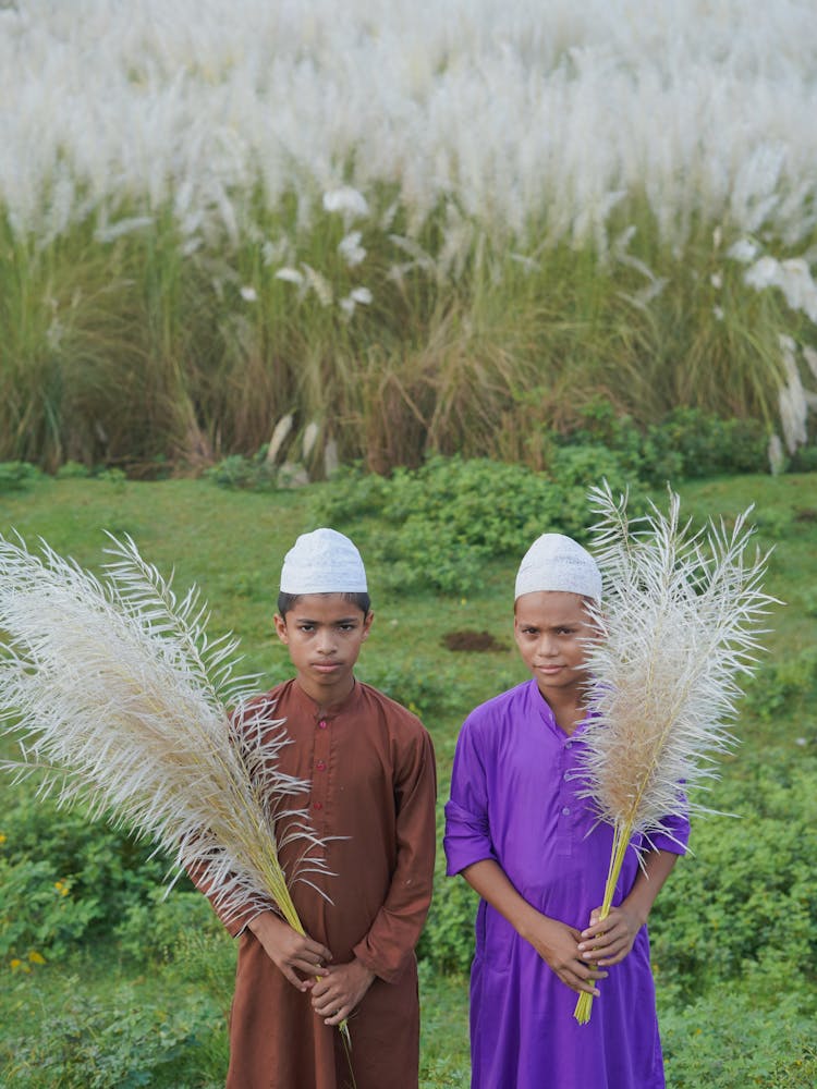 Little Boys Holding Pieces Of Pampas Grass