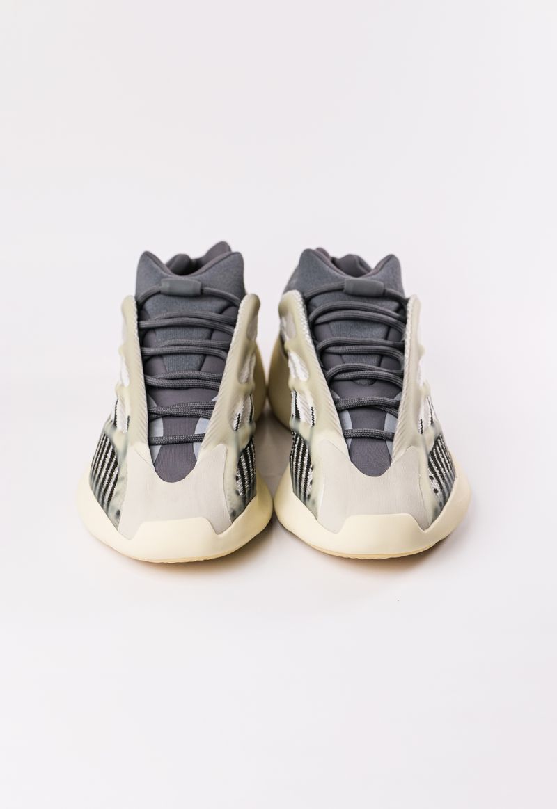 Pair of high-top sneakers on a pale studio backdrop — photo by Luis Quintero on Pexels