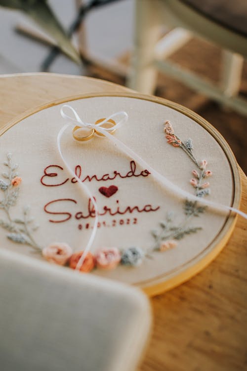 Engagement Rings and Embroidered Names of a Couple 