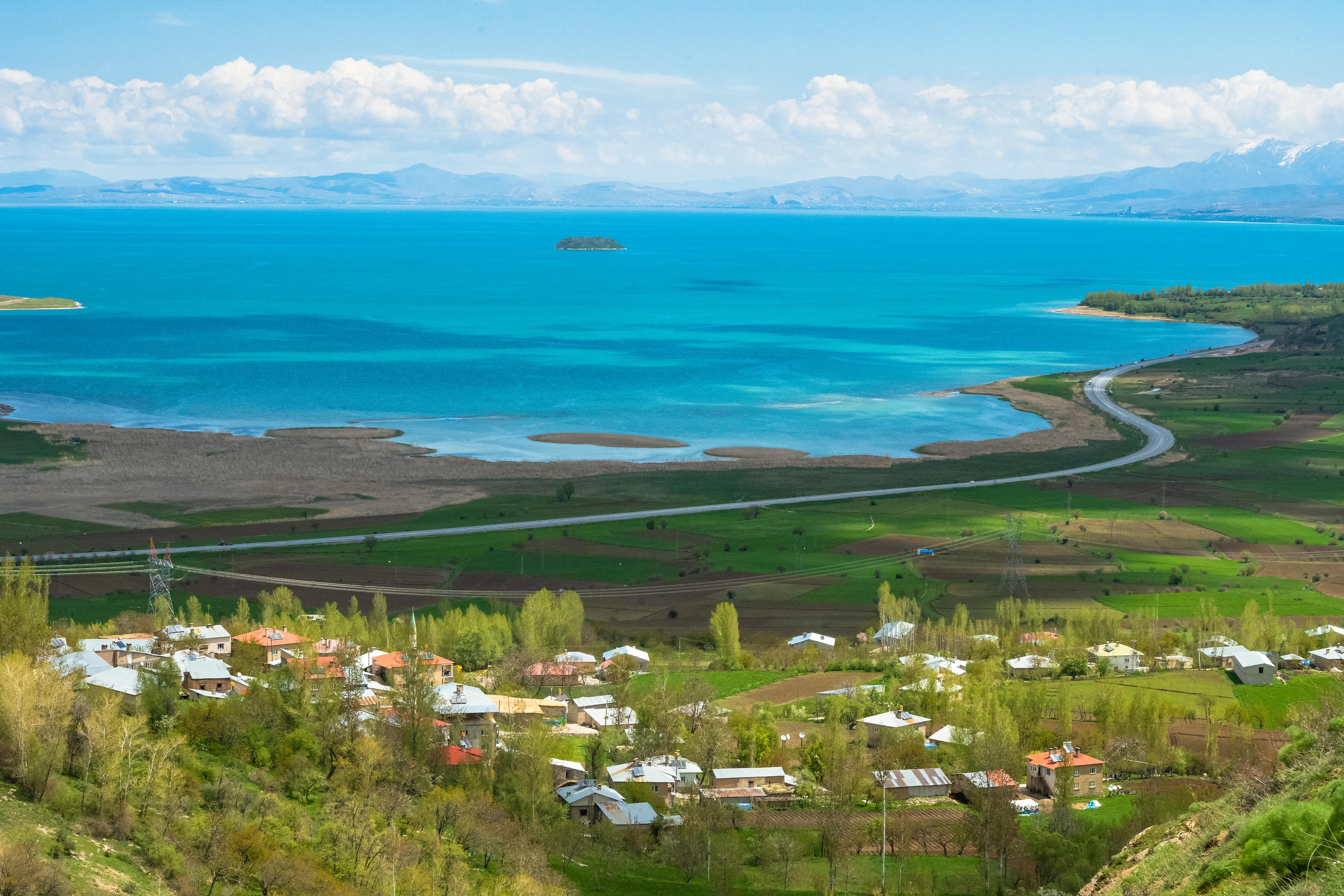 Breathtaking aerial view of Van Lake and Gevaş village with vibrant landscapes.