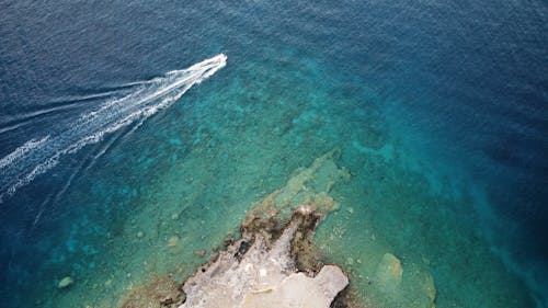 Aerial View of a Motorboat in Turquoise Water 