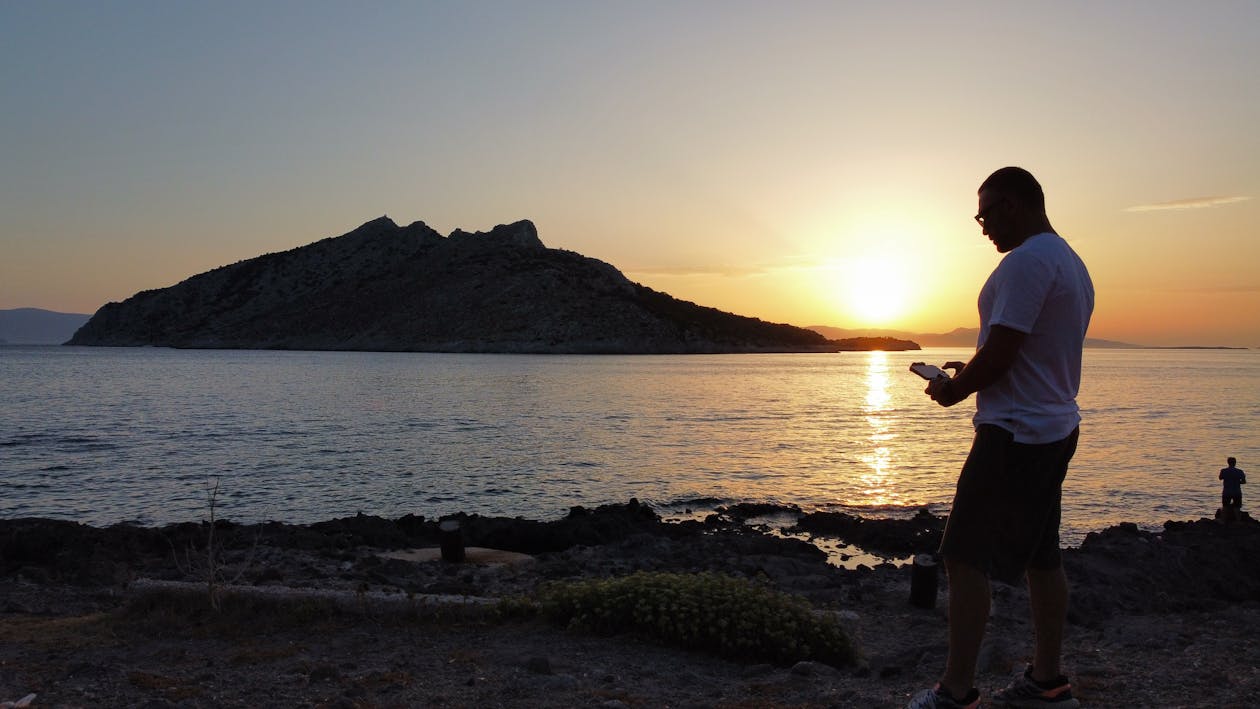 Man Standing on the Beach at Sunset 