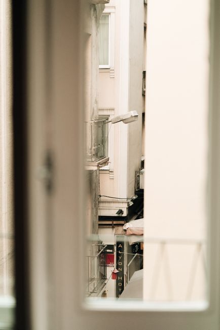 A glimpse of Istanbul's urban architecture through a window, showcasing narrow streets and classic facades.