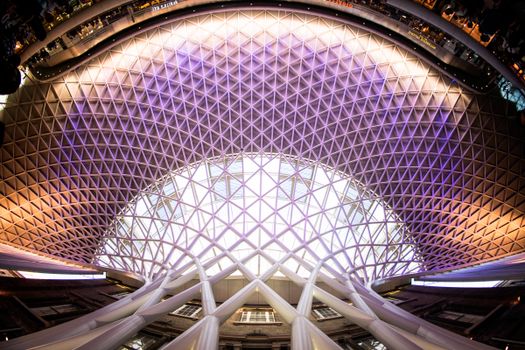 Stunning fisheye view of the modern architectural ceiling at a London train station, beautifully lit.