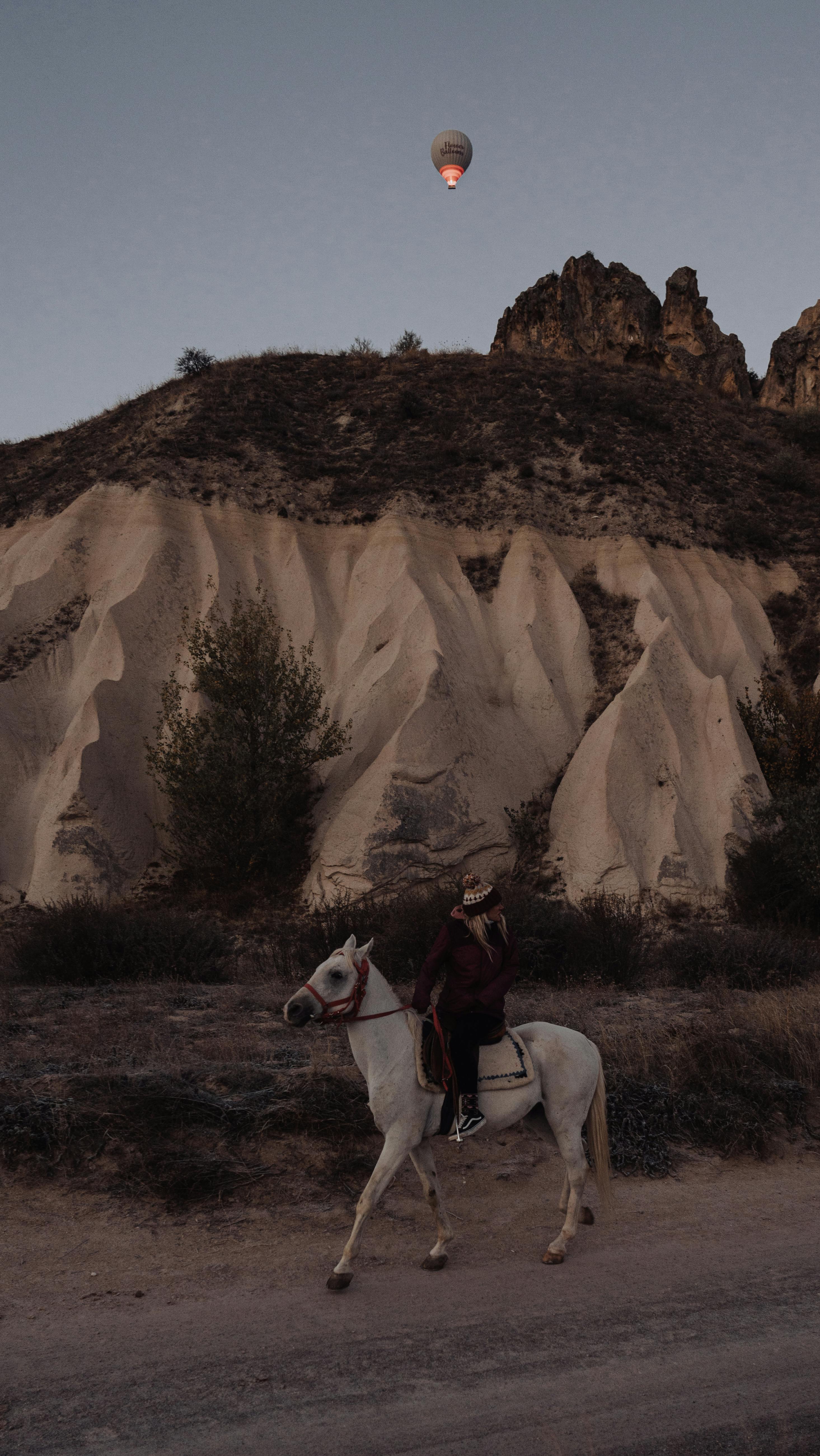 Explore Göreme's unique landscape with a horse ride and hot air balloon in the morning light.