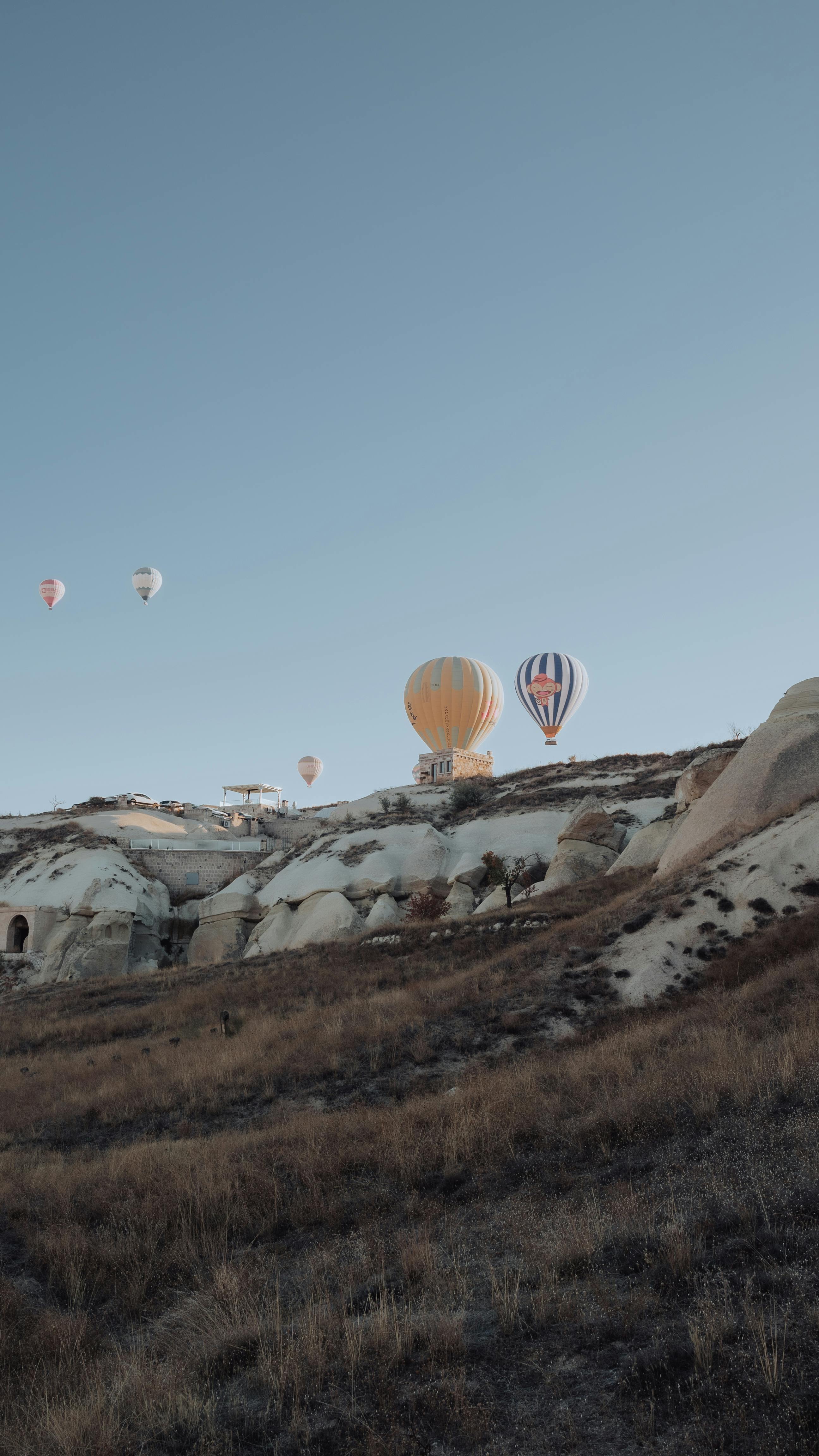 Stunning view of hot air balloons soaring above the unique rock formations of Göreme, Turkey.
