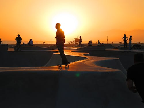 Photo of Skaters on Skatepark during Sunset
