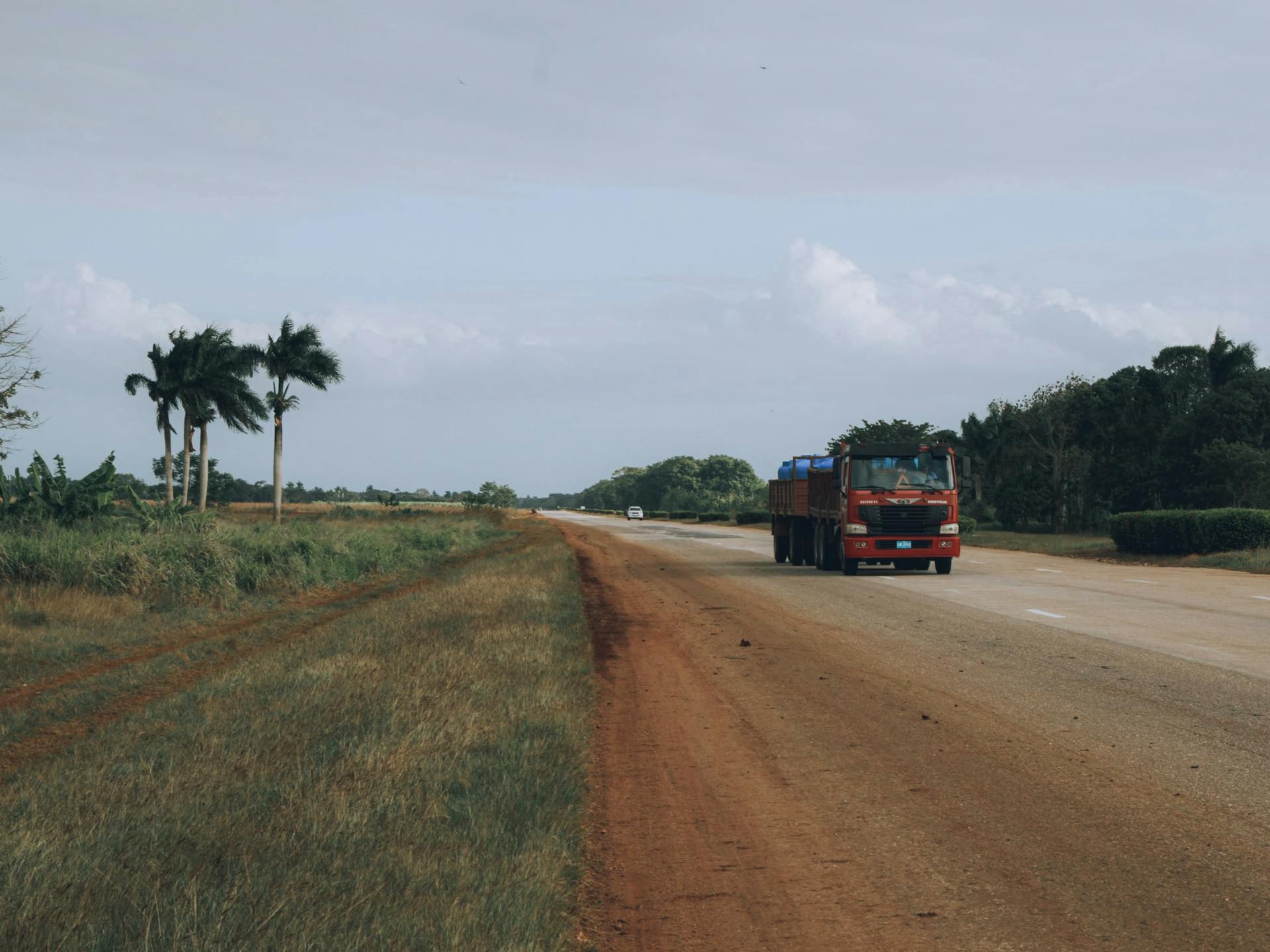 Red Truck on Brown Dirt Road