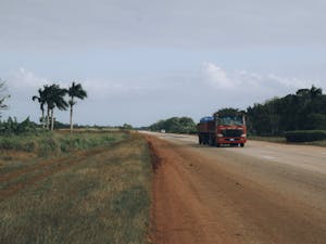 Red Truck on Brown Dirt Road