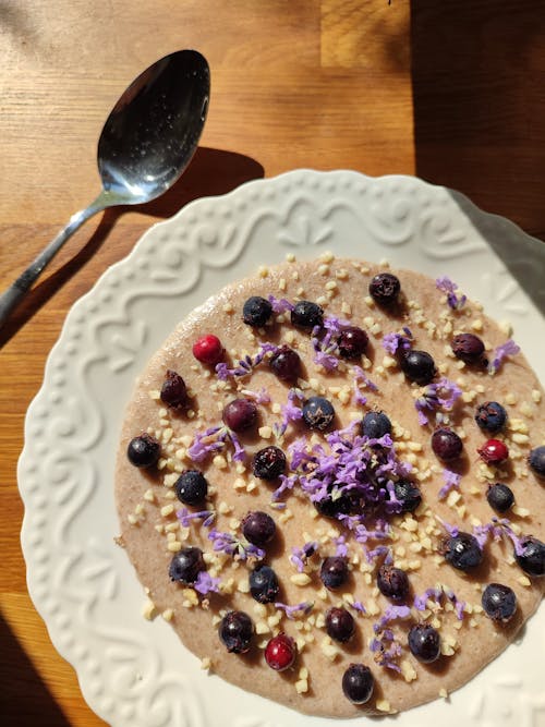 Top View of a Blueberry Porridge on a Decorative White Plate