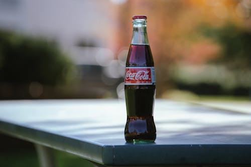 A Coca Cola Bottle on Grey Table