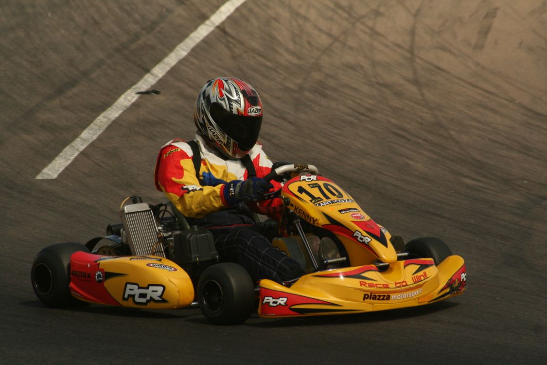 Race Wearing a Helmet Racing a Go Kart · Free Stock Photo