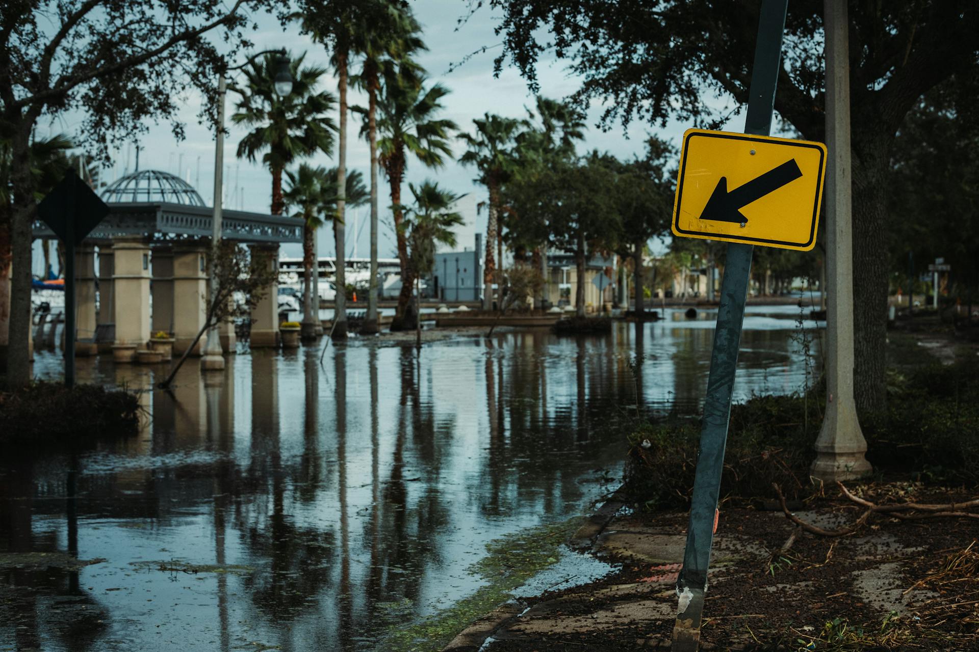 A Street Sign near the Flooded Road