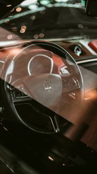 A close-up view of the Maserati Ghibli steering wheel emphasizes its luxury appeal.