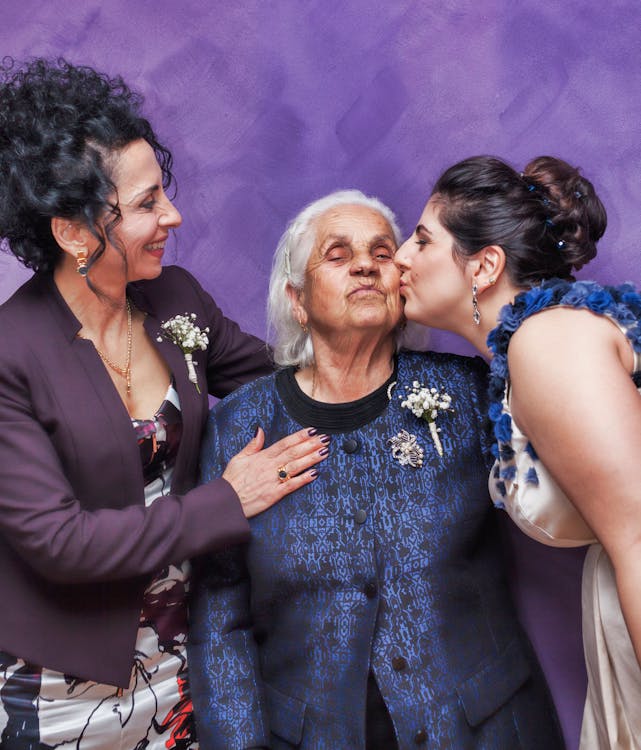 Free Woman Kissing Woman's Cheek Stock Photo