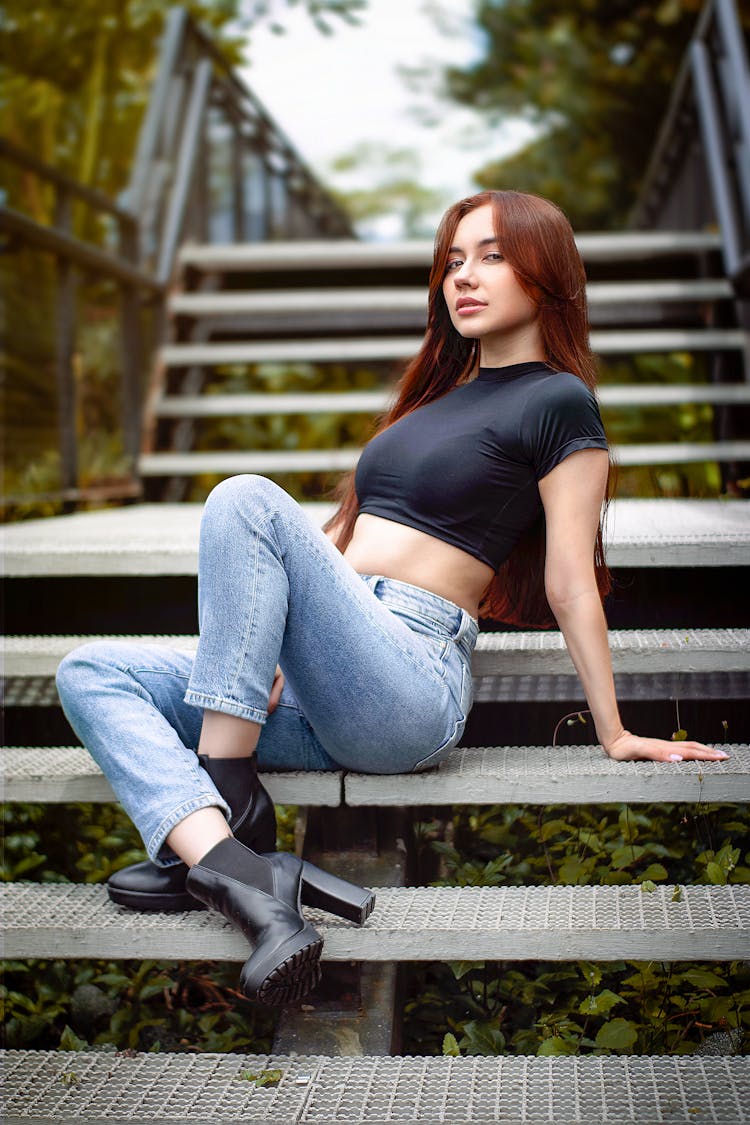 Young Woman Posing On Steps Outdoors 