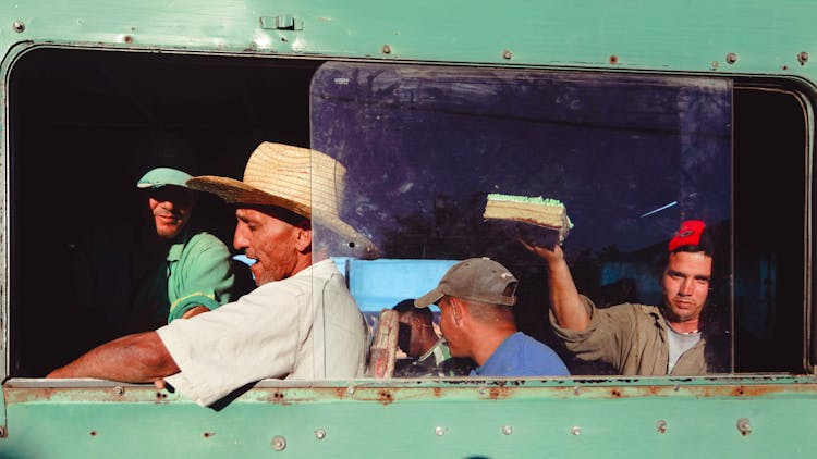 Men Driving In Retro Bus Near Window