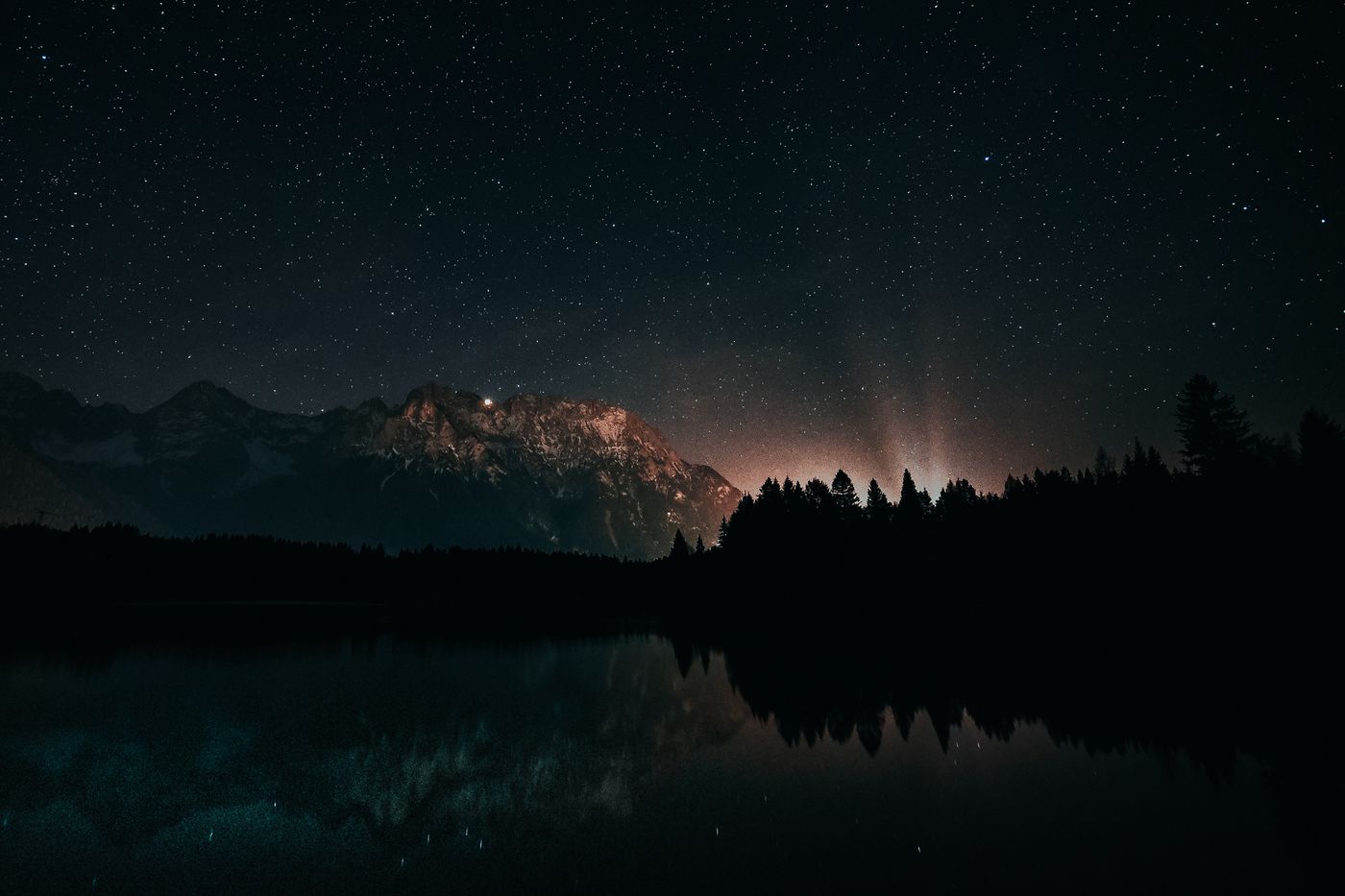 A starry night sky over mountains