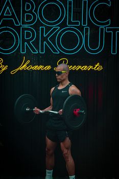 Athlete lifting weights in modern gym with neon lights, showcasing fitness and strength.