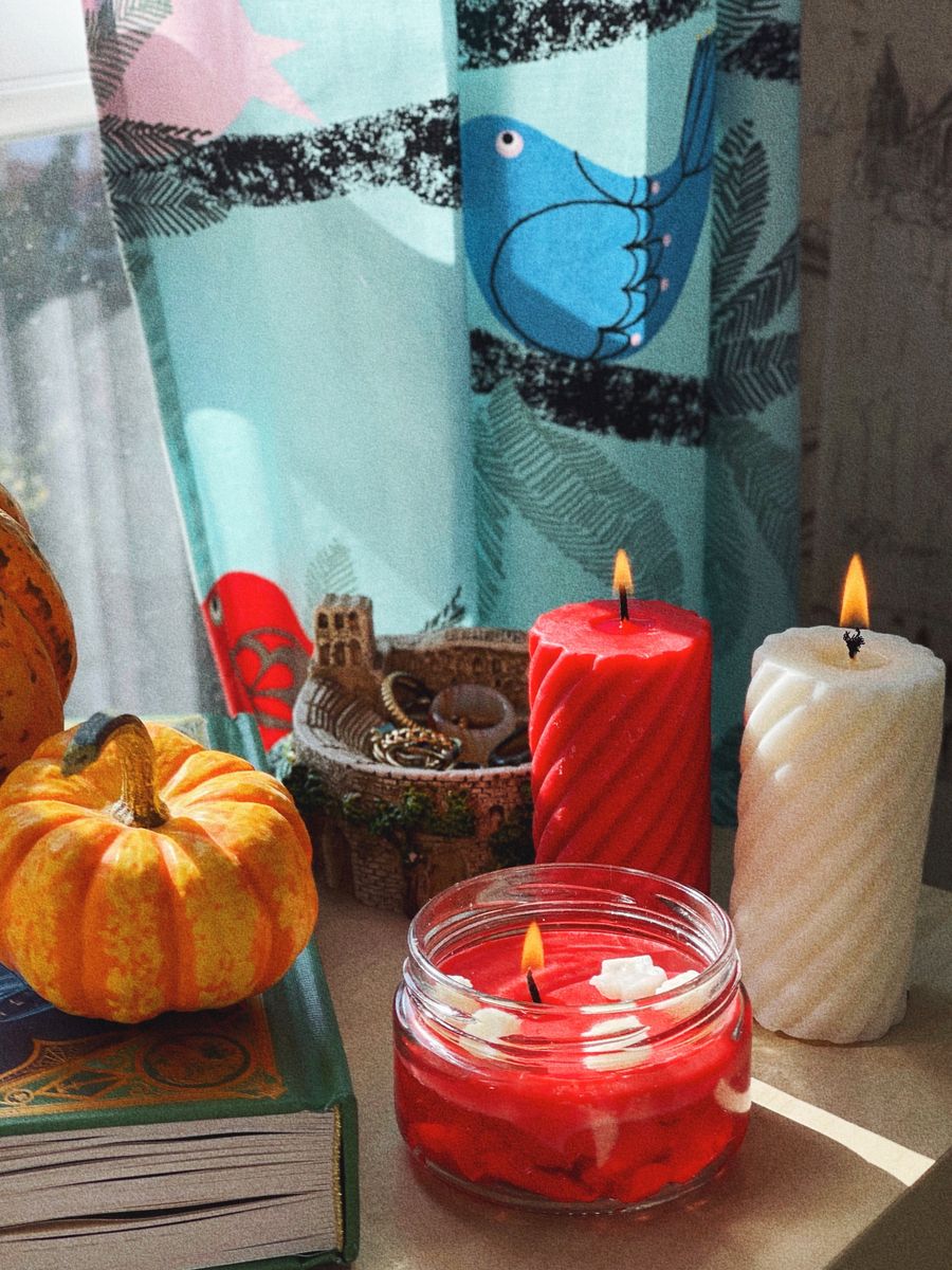 Warm autumn candles and pumpkin decorations