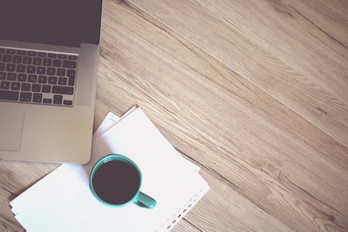 Free Gray Laptop Computer Beside Green Ceramic Mug Stock Photo