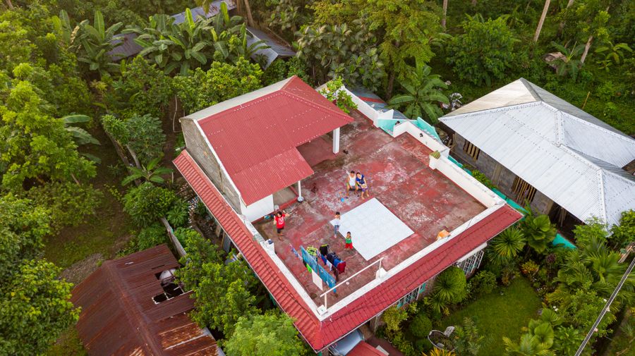 Aerial view focused on residential rooftops and exterior property conditions