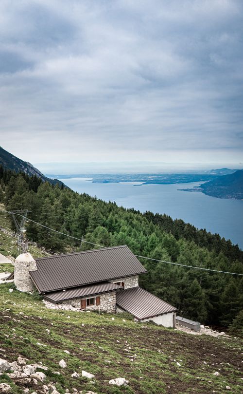 Free Charming stone house on Monte Baldo with view of Lake Garda and lush forest. Stock Photo
