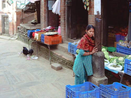 Woman Selling Vegetables on City Street