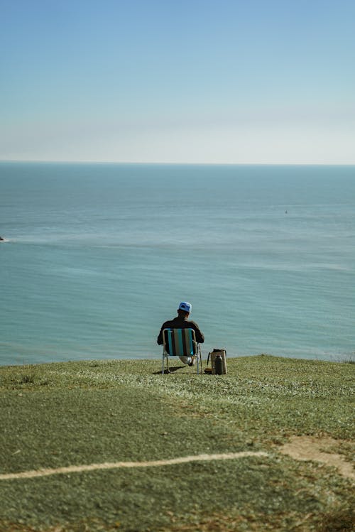 Man Sitting on Sea Shore