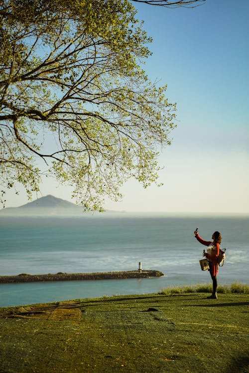 Woman on the Shore with the View of a Volcano 