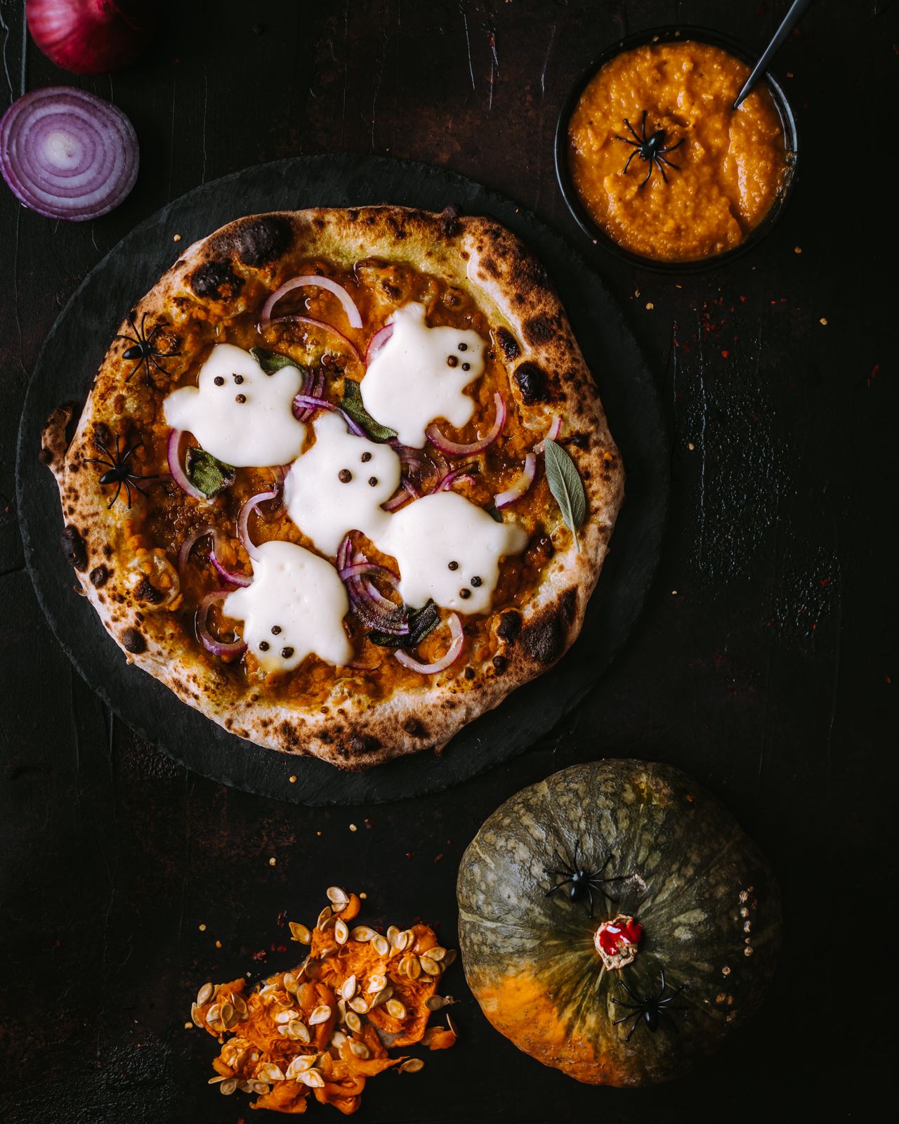 Halloween pizza topped with ghost-shaped cheese