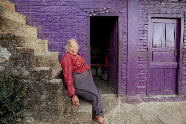 Elderly Woman Sitting On Steps