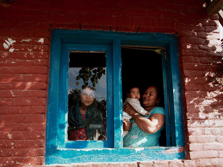 Family Looking Out Of House Window