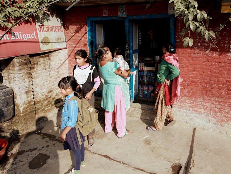 Women With Children Near Shop Entrance