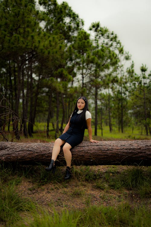 Woman Posing on Tree Trunk