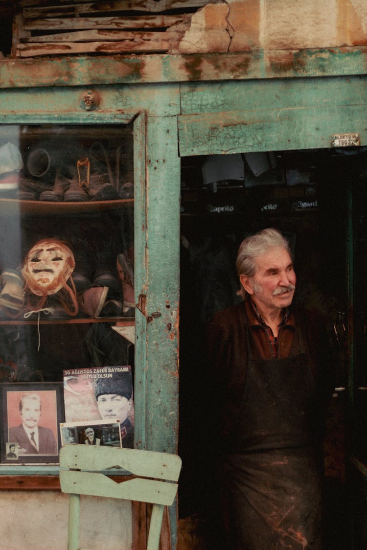 Elderly Man In Old Store Entrance