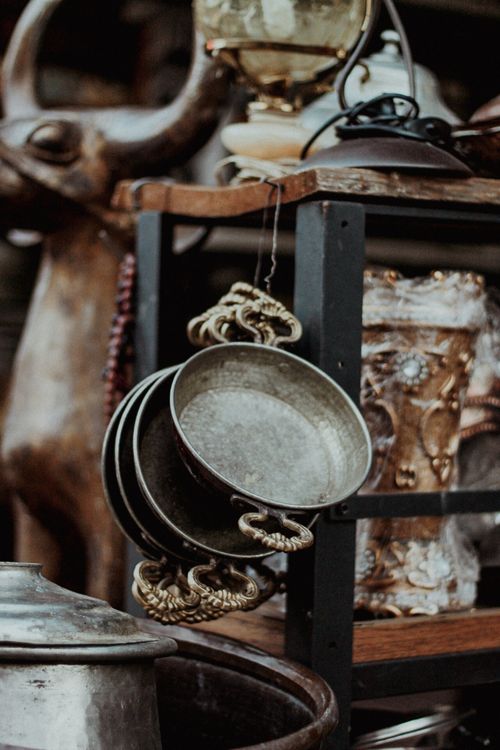 Free A variety of antique metal pots and vases displayed on a market stall with rustic charm. Stock Photo
