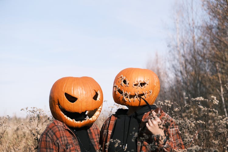 People Wearing Spooky Pumpkin On Heads