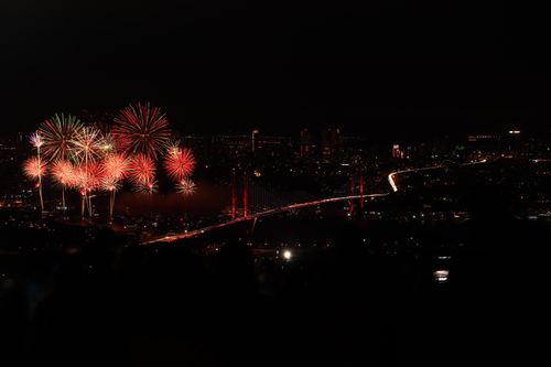 Free Captivating fireworks light up the night sky over Istanbul's Bosphorus Bridge, creating a stunning urban spectacle. Stock Photo