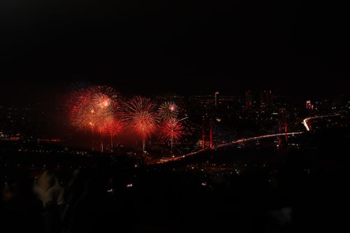 Free Spectacular fireworks display over the Bosphorus Bridge in Istanbul, capturing vibrant night skyline. Stock Photo